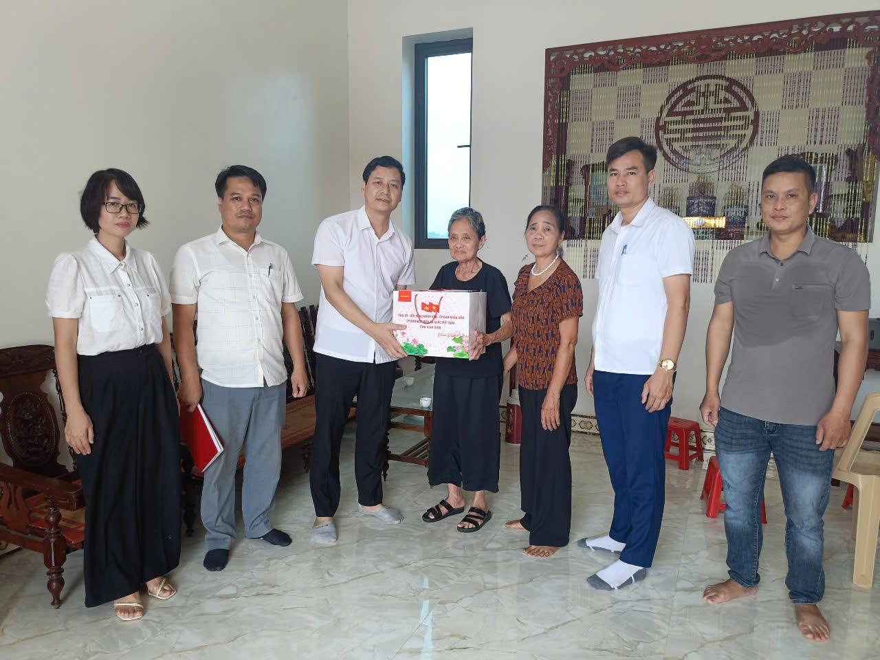 A group of people standing together holding a box  AI-generated content may be incorrect.